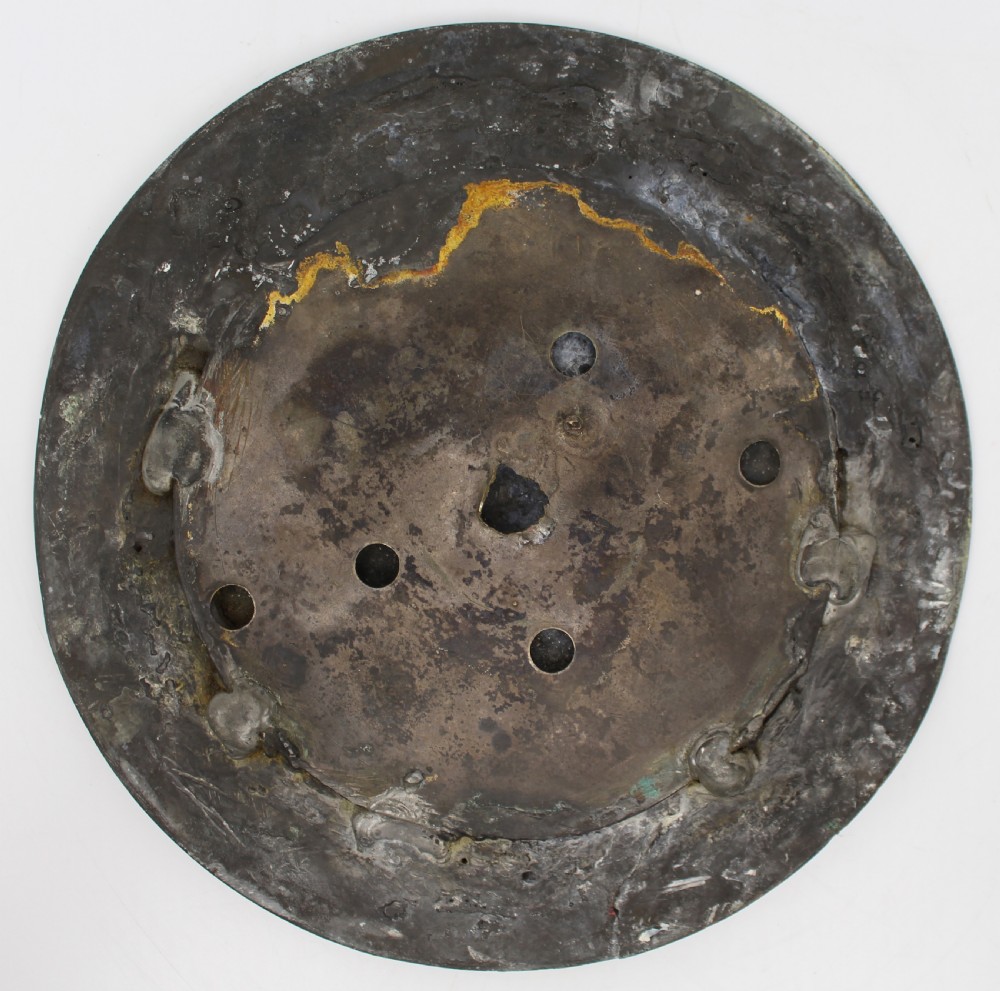 A circular antique copper relief plaque depicting a bear with prey in a rocky forest setting under an oak branch. View VI