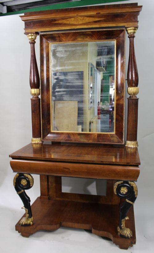 fig 2. An antique mahogany pier console table featuring carved parcel gilt columns, ebonised monopodia legs with paw feet, and an integrated rectangular pier mirror.