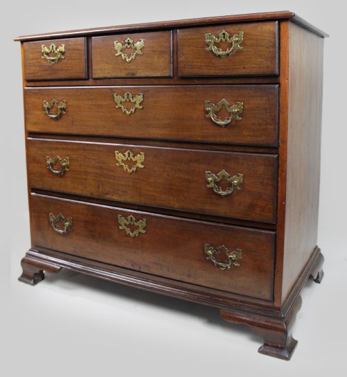 fig 1. An 18th-century George III mahogany chest of drawers featuring three small upper drawers over three long drawers, fitted with brass handles and supported on bracket feet.