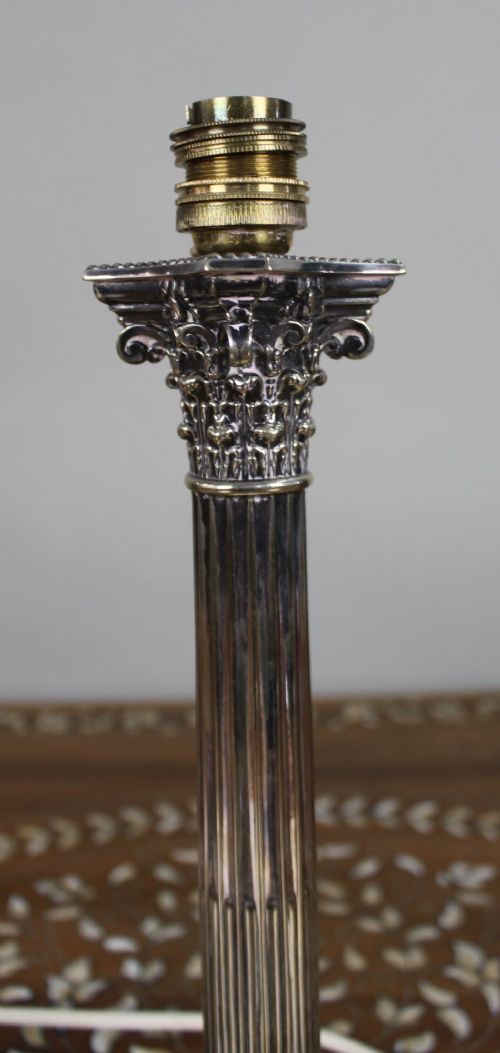 A silver-plated table lamp featuring a fluted Corinthian column shaft, a stepped square base, and a cream pleated fabric shade. View XI