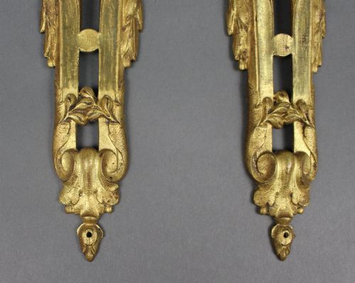 fig 2. A pair of ornate gilt bronze furniture mounts featuring acanthus leaf scrollwork and symmetrical pierced design in the Louis XVI style.