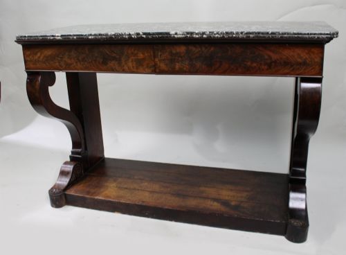 fig 2. An antique dark mahogany French console table featuring a grey and white mottled marble top, curved scroll legs, and a low plinth shelf.