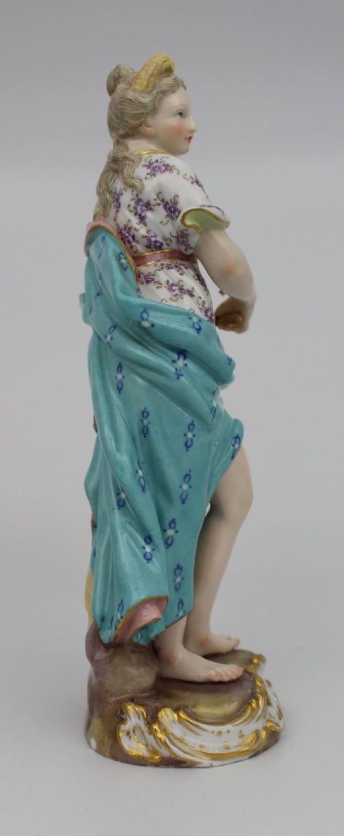 A set of four 19th-century hand-painted porcelain figurines representing the seasons standing on gilded scroll bases. View XI