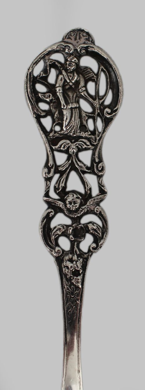 An antique Flemish silver spoon featuring an intricately pierced bowl decorated with a figurative orchard scene and a scrolling openwork handle. View VI