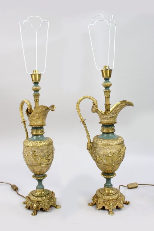 fig 1. A pair of late nineteenth-century gilt metal table lamps fashioned in the shape of classical ewers with relief carving and green painted accents.