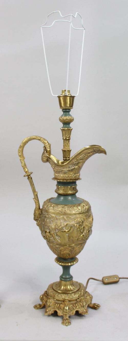A pair of late nineteenth-century gilt metal table lamps fashioned in the shape of classical ewers with relief carving and green painted accents. View IV