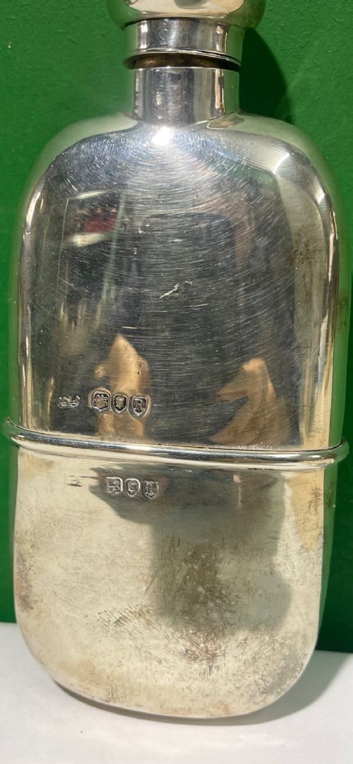 A late Victorian sterling silver spirit flask featuring a domed top and visible London hallmark stamps on the body. View II