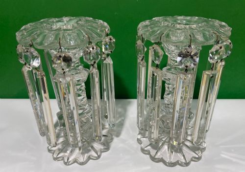 fig 1. A pair of clear cut glass table lustres featuring faceted stems, starburst cut bases, and hanging crystal prism drops suspended from wire hooks.