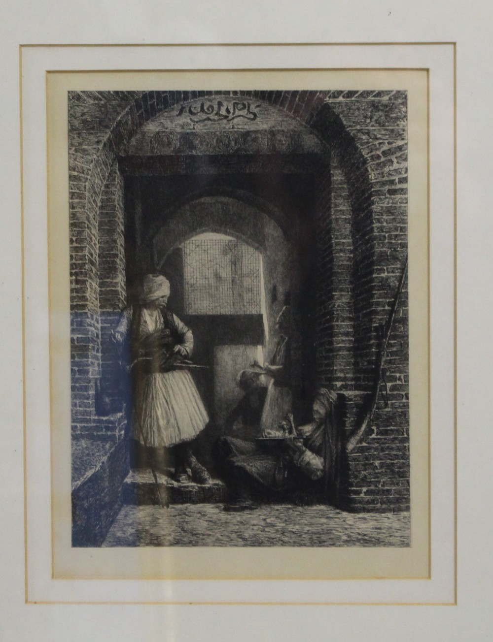 A Victorian monochrome etching depicting figures in traditional costume within an arched brick passage, presented inside a double mount and a thin gilded wooden frame. View II