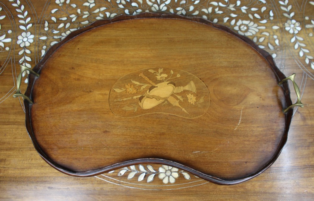 A kidney-shaped mahogany serving tray with central marquetry inlay, a scalloped gallery rim, and two brass handles. View VI
