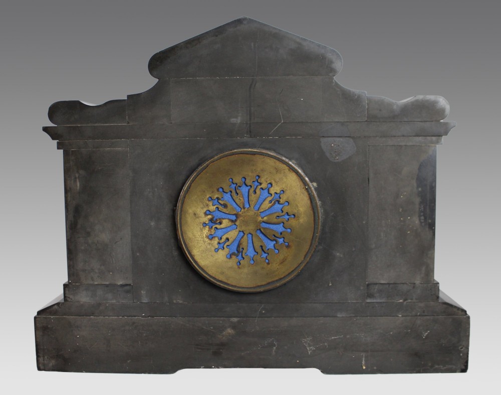 A High Victorian architectural mantel clock crafted from black slate with red rouge marble columns, a brass dial, and gilt floral engravings. View VII
