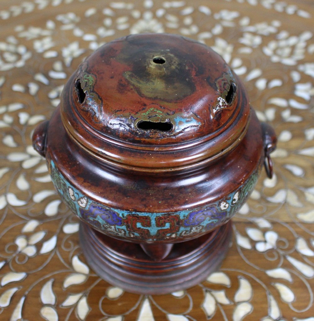 An antique Chinese bronze tripod censer featuring a band of turquoise and blue cloisonne enamel work, mask handles with loose rings, and a pierced lid. View II