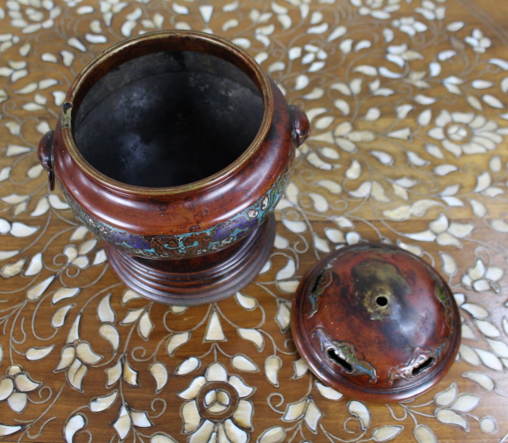 An antique Chinese bronze tripod censer featuring a band of turquoise and blue cloisonne enamel work, mask handles with loose rings, and a pierced lid. View VI