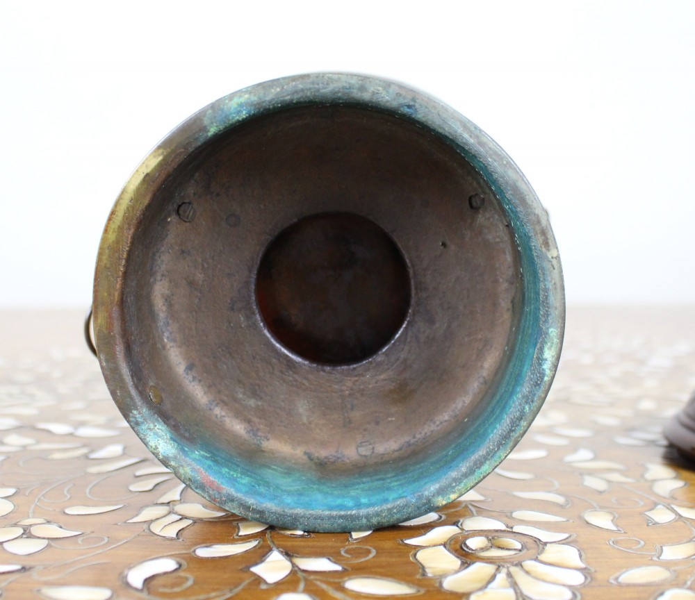 An antique Chinese bronze tripod censer featuring a band of turquoise and blue cloisonne enamel work, mask handles with loose rings, and a pierced lid. View VII