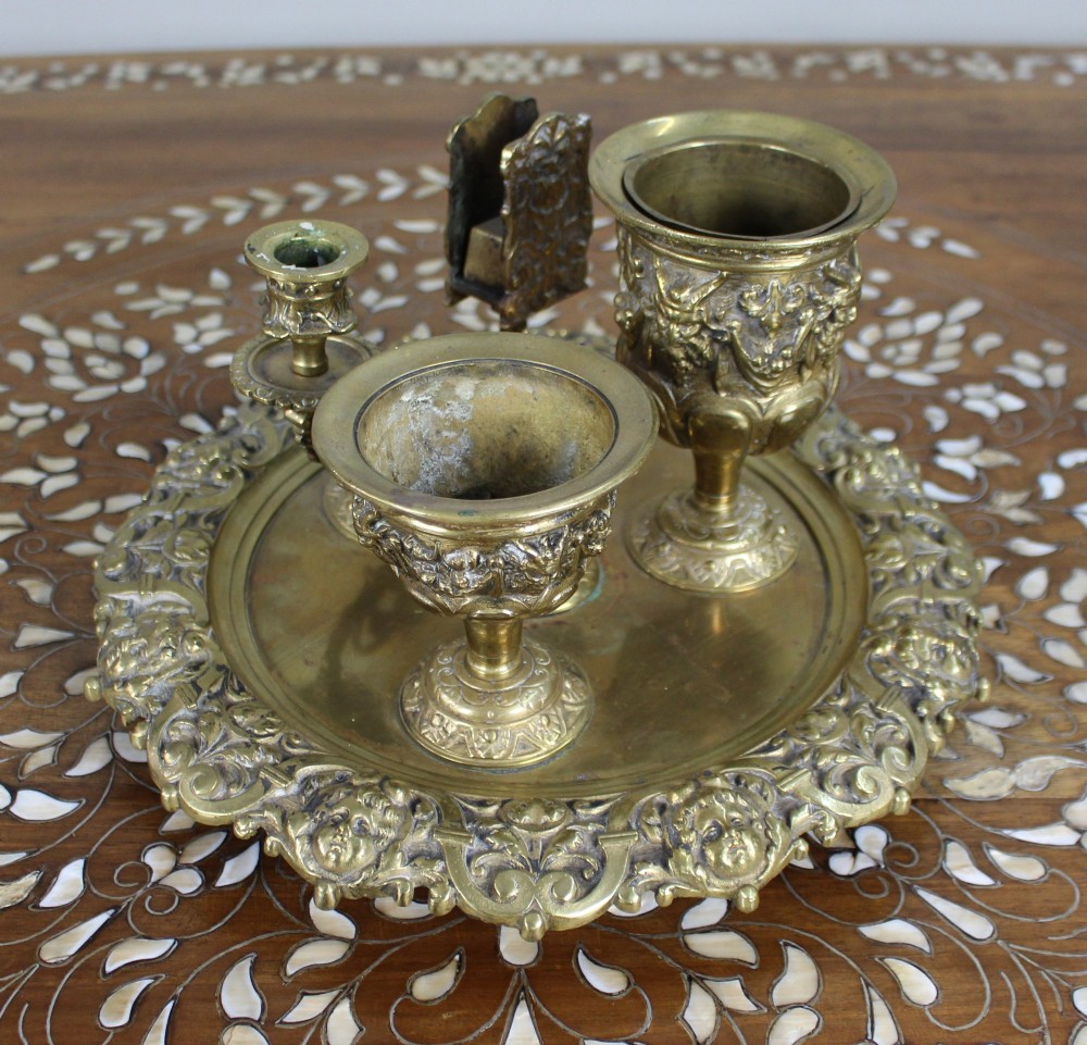 A 19th-century cast brass writing desk set featuring an ornate rimmed tray, two urn-shaped pots, and a small chamberstick. View II