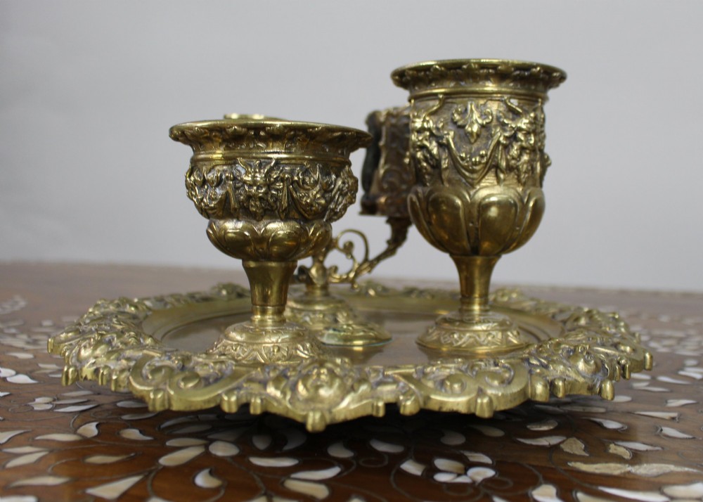 A 19th-century cast brass writing desk set featuring an ornate rimmed tray, two urn-shaped pots, and a small chamberstick. View III