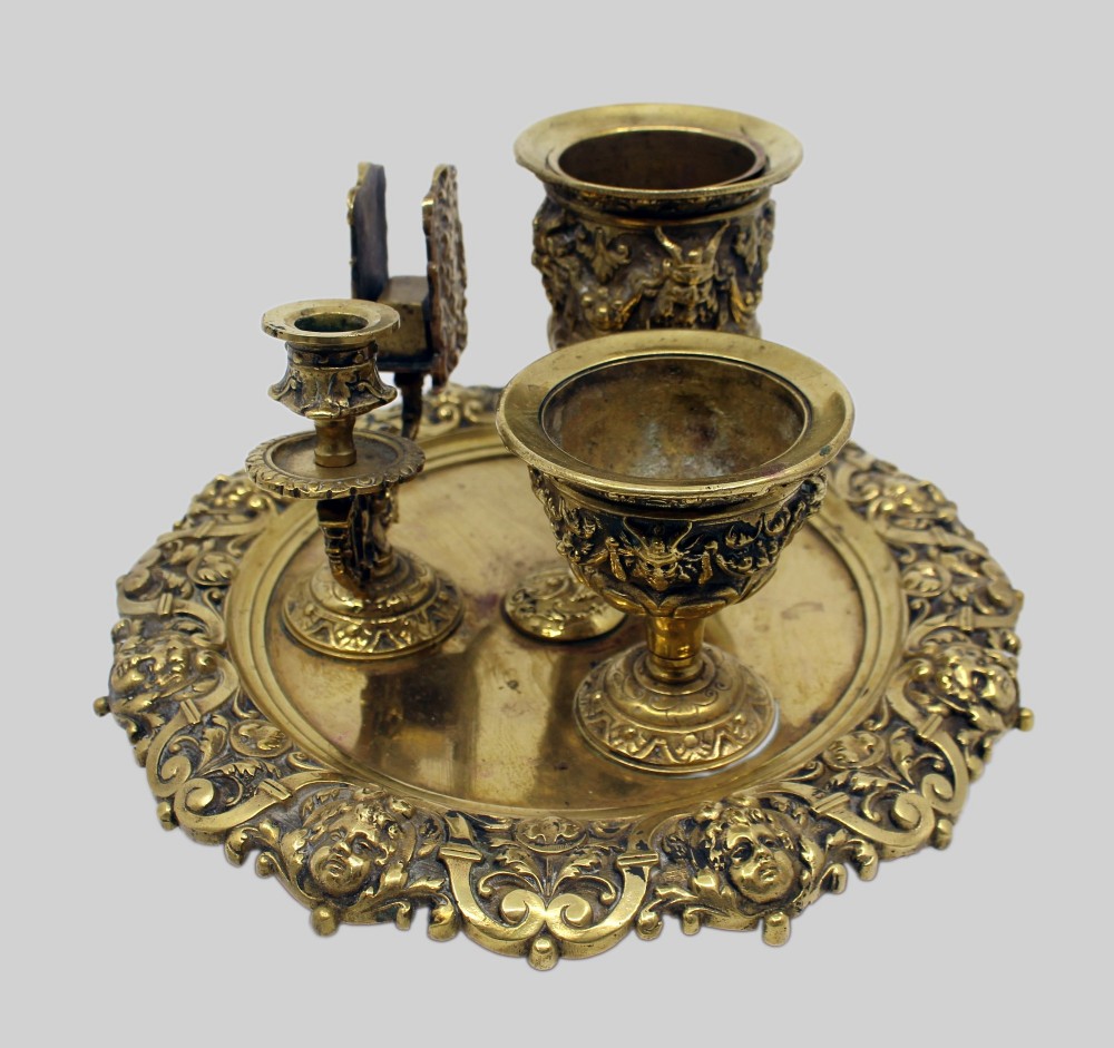 A 19th-century cast brass writing desk set featuring an ornate rimmed tray, two urn-shaped pots, and a small chamberstick. View IV
