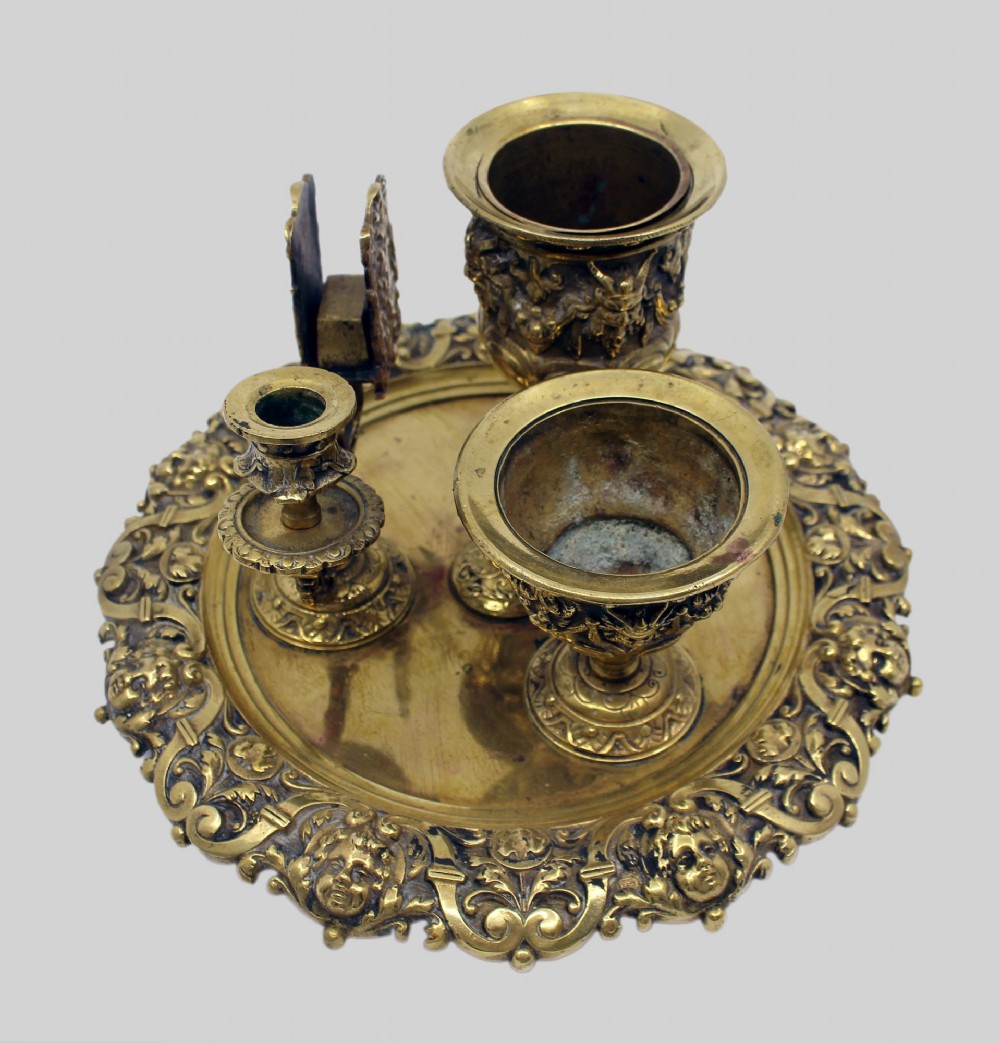 A 19th-century cast brass writing desk set featuring an ornate rimmed tray, two urn-shaped pots, and a small chamberstick. View VIII