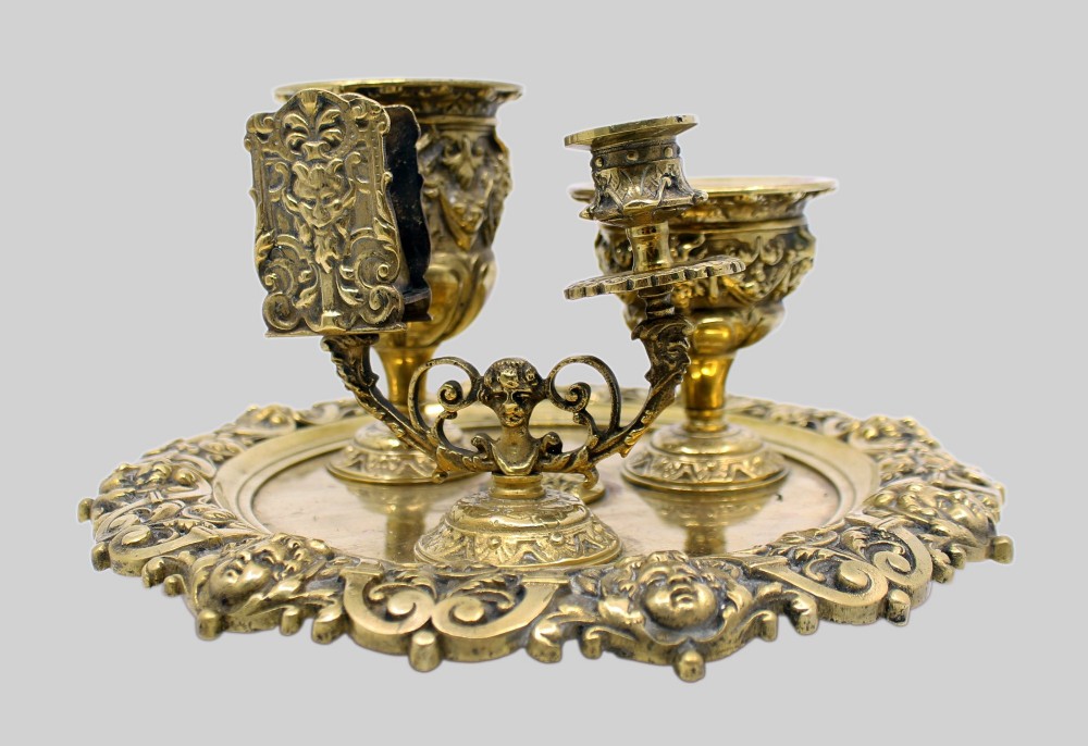 A 19th-century cast brass writing desk set featuring an ornate rimmed tray, two urn-shaped pots, and a small chamberstick. View IX