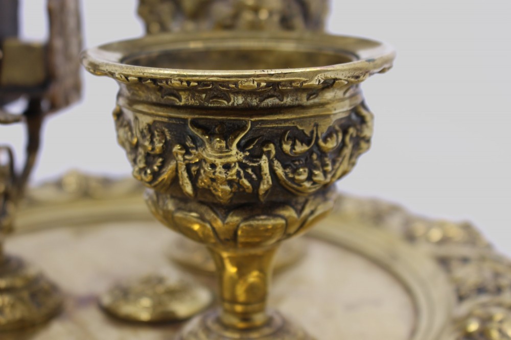 A 19th-century cast brass writing desk set featuring an ornate rimmed tray, two urn-shaped pots, and a small chamberstick. View XI