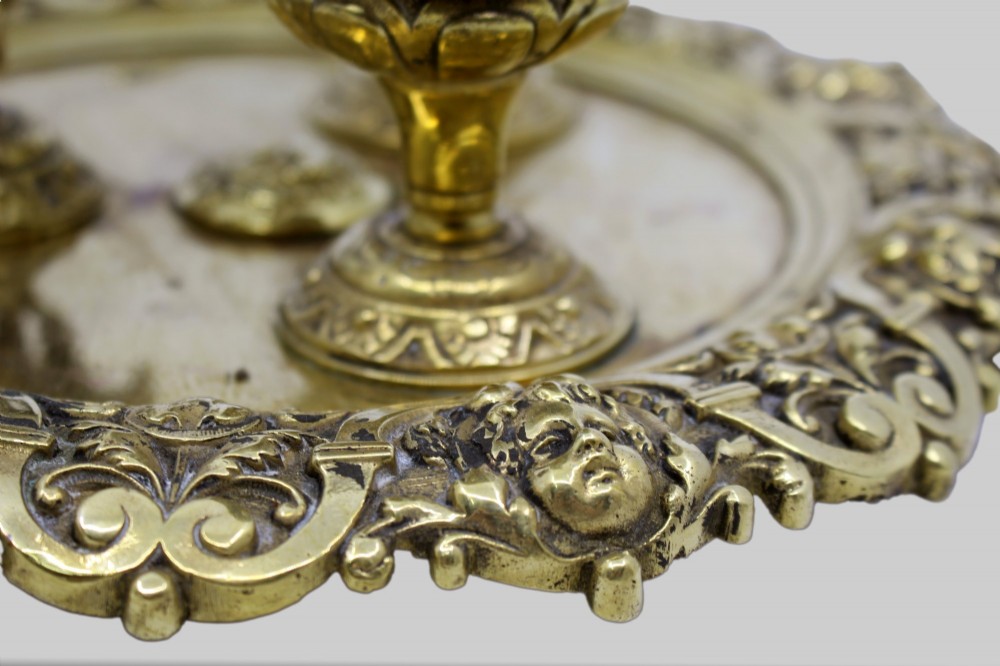A 19th-century cast brass writing desk set featuring an ornate rimmed tray, two urn-shaped pots, and a small chamberstick. View XII