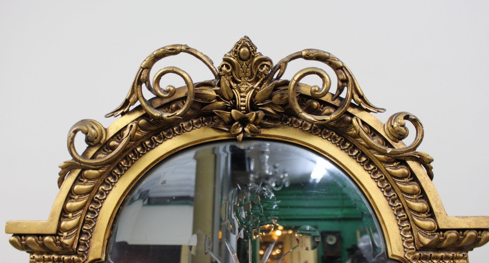 A Regency giltwood pier mirror with ornate cresting, beaded frame details, and an upper arched mirror section featuring intaglio cut floral designs. View III