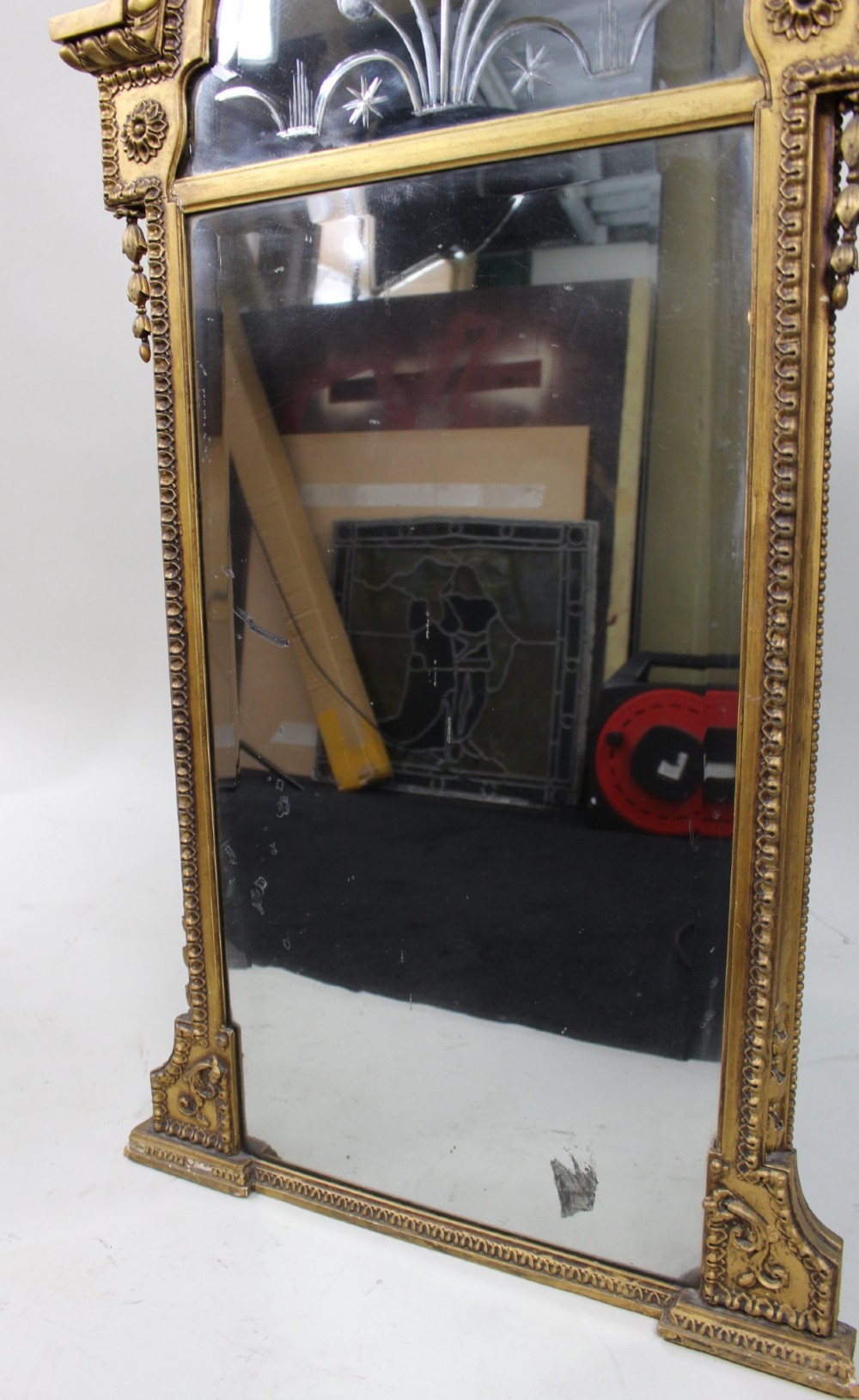 A Regency giltwood pier mirror with ornate cresting, beaded frame details, and an upper arched mirror section featuring intaglio cut floral designs. View V