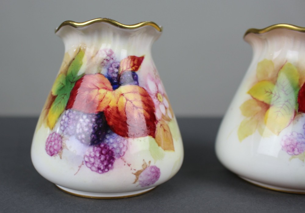 A pair of small white porcelain vases with wavy gilded rims, hand-painted with ripe blackberries, blossoms, and autumn foliage. View II