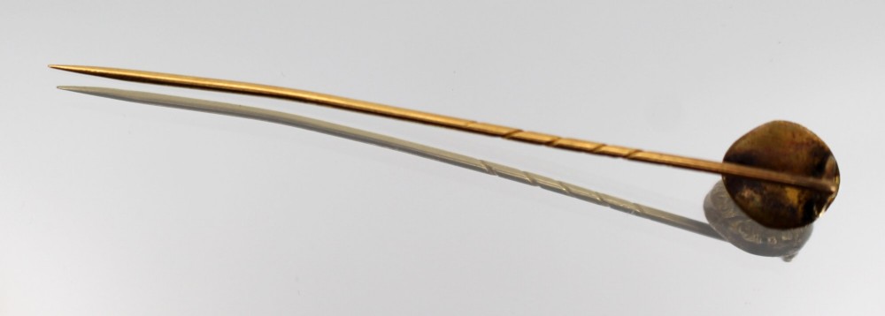 An antique Victorian gold stick pin featuring a relief-carved classical mask head atop a slender twisted shaft. View III