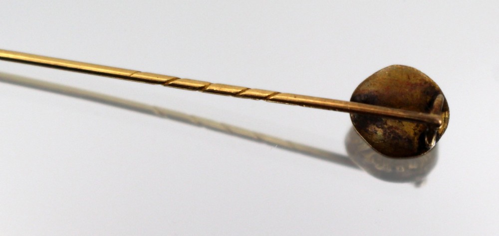 An antique Victorian gold stick pin featuring a relief-carved classical mask head atop a slender twisted shaft. View IV