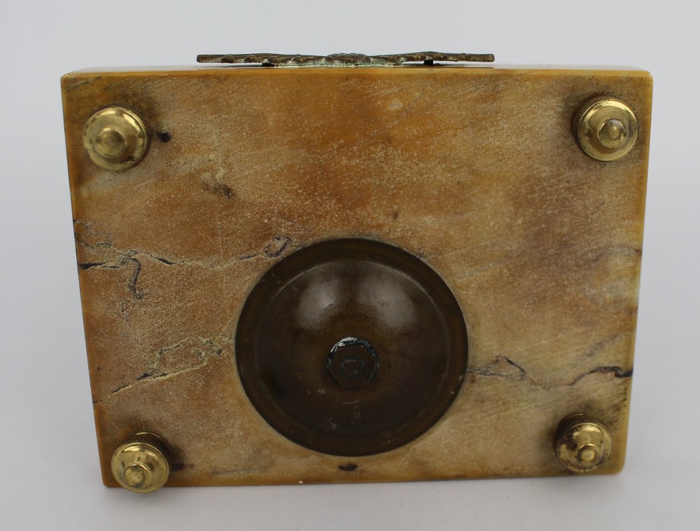 A rectangular yellow Siena marble desk inkstand featuring a central patterned ormolu inkpot with a finial lid, a front brass leaf applique, and small turned metal feet. View XII