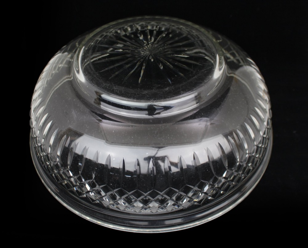 A clear cut crystal jug featuring a diamond motif seated inside a matching large round cut crystal basin. View XI