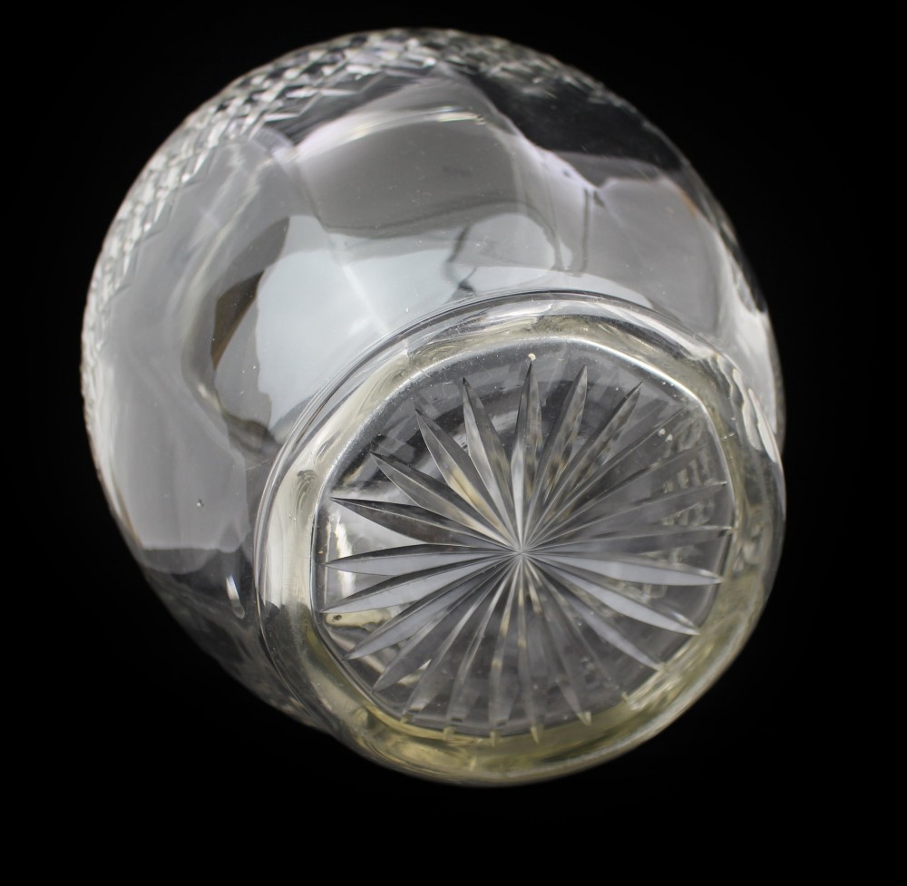 A clear cut crystal jug featuring a diamond motif seated inside a matching large round cut crystal basin. View XIII