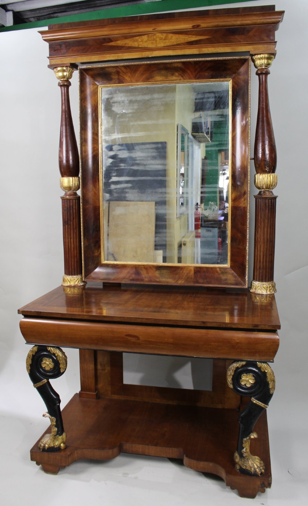 An antique mahogany pier console table featuring carved parcel gilt columns, ebonised monopodia legs with paw feet, and an integrated rectangular pier mirror. View III