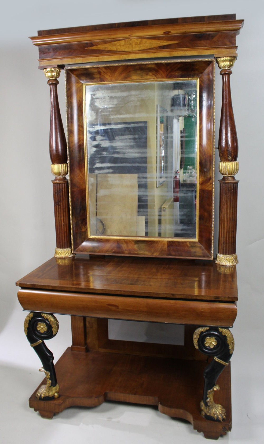 An antique mahogany pier console table featuring carved parcel gilt columns, ebonised monopodia legs with paw feet, and an integrated rectangular pier mirror. View IV
