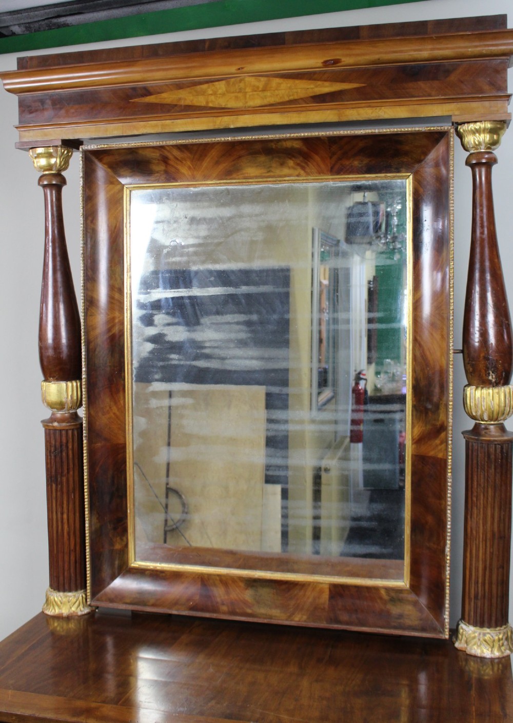 An antique mahogany pier console table featuring carved parcel gilt columns, ebonised monopodia legs with paw feet, and an integrated rectangular pier mirror. View V