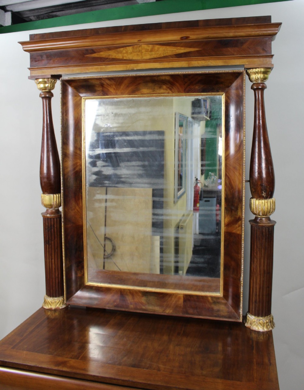An antique mahogany pier console table featuring carved parcel gilt columns, ebonised monopodia legs with paw feet, and an integrated rectangular pier mirror. View VI