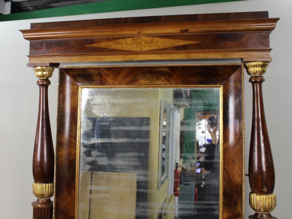 An antique mahogany pier console table featuring carved parcel gilt columns, ebonised monopodia legs with paw feet, and an integrated rectangular pier mirror. View VII