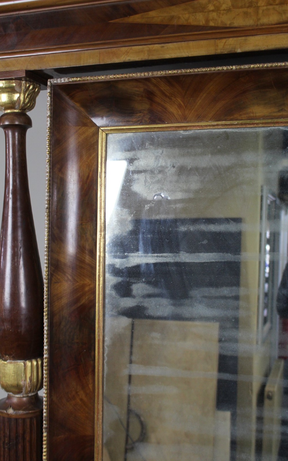 An antique mahogany pier console table featuring carved parcel gilt columns, ebonised monopodia legs with paw feet, and an integrated rectangular pier mirror. View IX