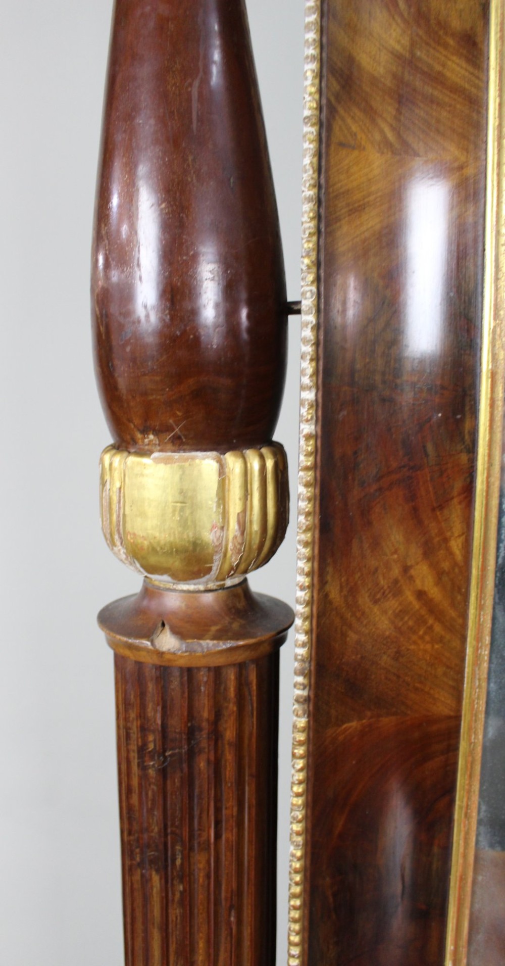 An antique mahogany pier console table featuring carved parcel gilt columns, ebonised monopodia legs with paw feet, and an integrated rectangular pier mirror. View X