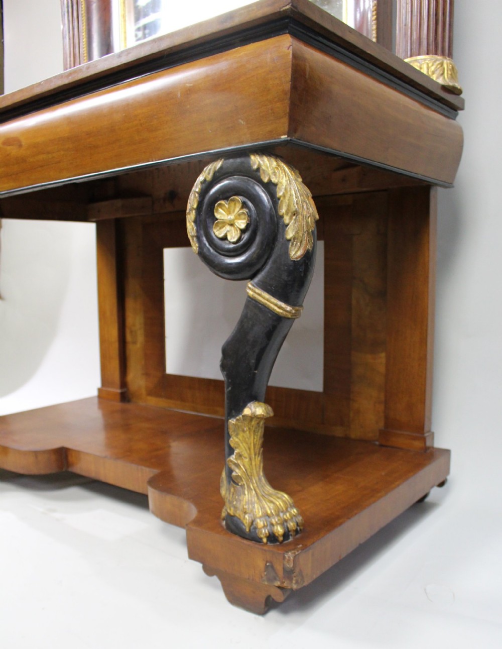 An antique mahogany pier console table featuring carved parcel gilt columns, ebonised monopodia legs with paw feet, and an integrated rectangular pier mirror. View XV
