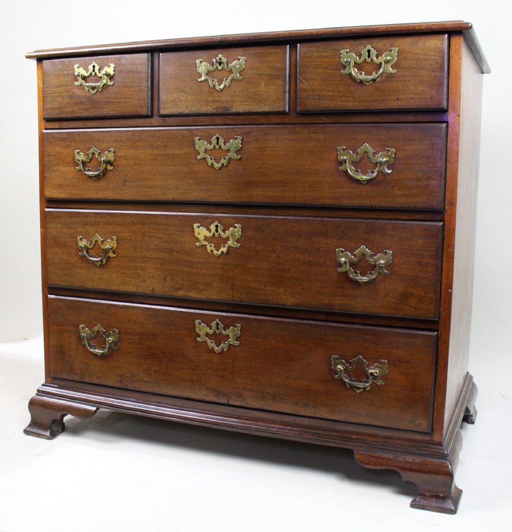 An 18th-century George III mahogany chest of drawers featuring three small upper drawers over three long drawers, fitted with brass handles and supported on bracket feet.