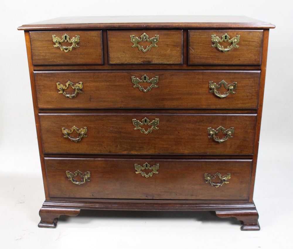 An 18th-century George III mahogany chest of drawers featuring three small upper drawers over three long drawers, fitted with brass handles and supported on bracket feet. View III