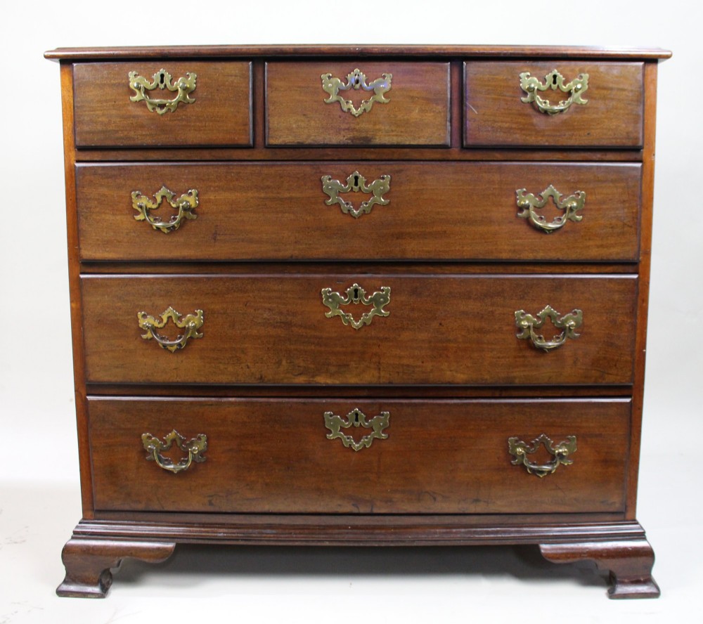 An 18th-century George III mahogany chest of drawers featuring three small upper drawers over three long drawers, fitted with brass handles and supported on bracket feet. View IV