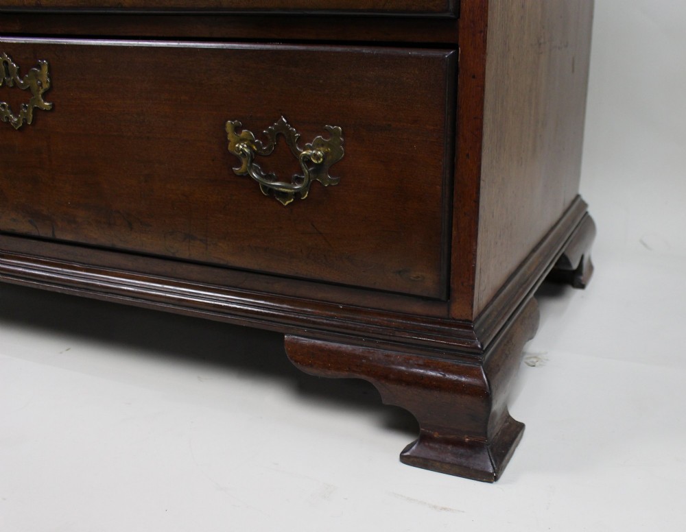 An 18th-century George III mahogany chest of drawers featuring three small upper drawers over three long drawers, fitted with brass handles and supported on bracket feet. View VI