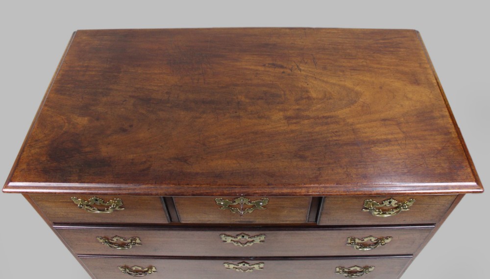An 18th-century George III mahogany chest of drawers featuring three small upper drawers over three long drawers, fitted with brass handles and supported on bracket feet. View VIII