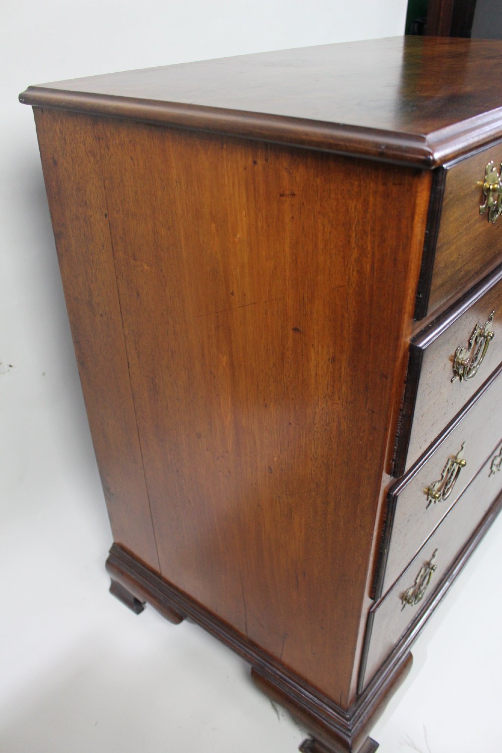 An 18th-century George III mahogany chest of drawers featuring three small upper drawers over three long drawers, fitted with brass handles and supported on bracket feet. View IX