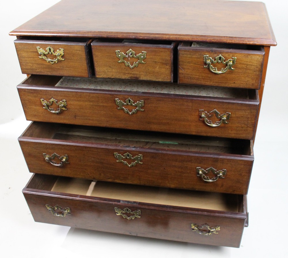 An 18th-century George III mahogany chest of drawers featuring three small upper drawers over three long drawers, fitted with brass handles and supported on bracket feet. View XI
