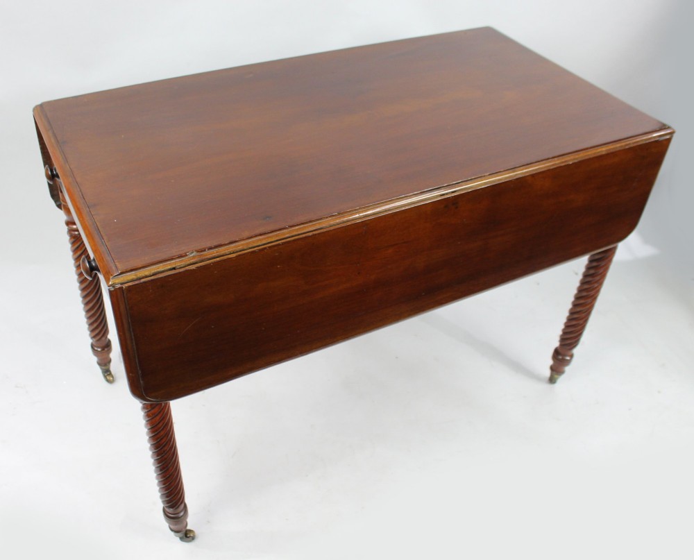 A Victorian mahogany Pembroke table with two hinged drop leaves, a single end drawer with turned wood knobs, spiral-twisted legs, and brass castors. View III