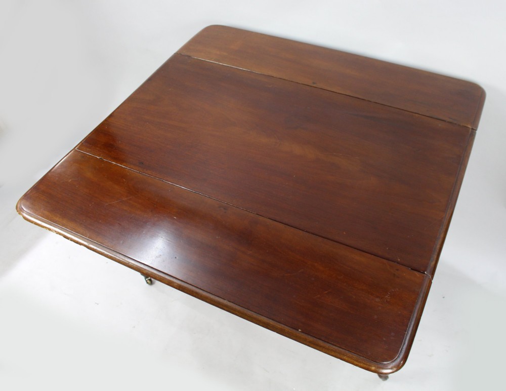 A Victorian mahogany Pembroke table with two hinged drop leaves, a single end drawer with turned wood knobs, spiral-twisted legs, and brass castors. View IV